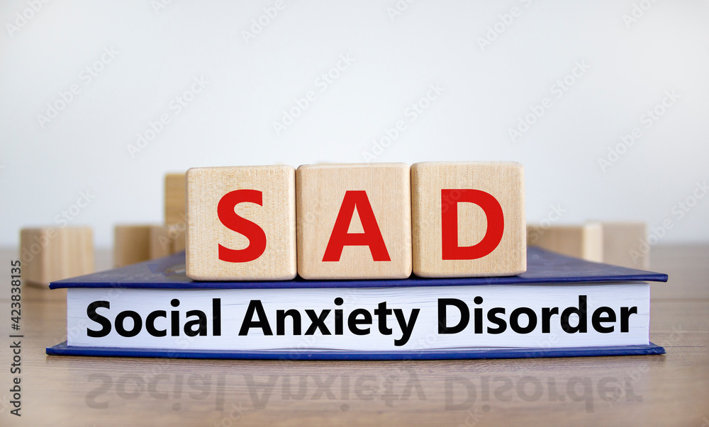 SAD, social anxiety disorder symbol. Concept words 'SAD, social anxiety disorder' on cubes on a beautiful white background. Medical, psychological and SAD, social anxiety disorder concept. Copy space.