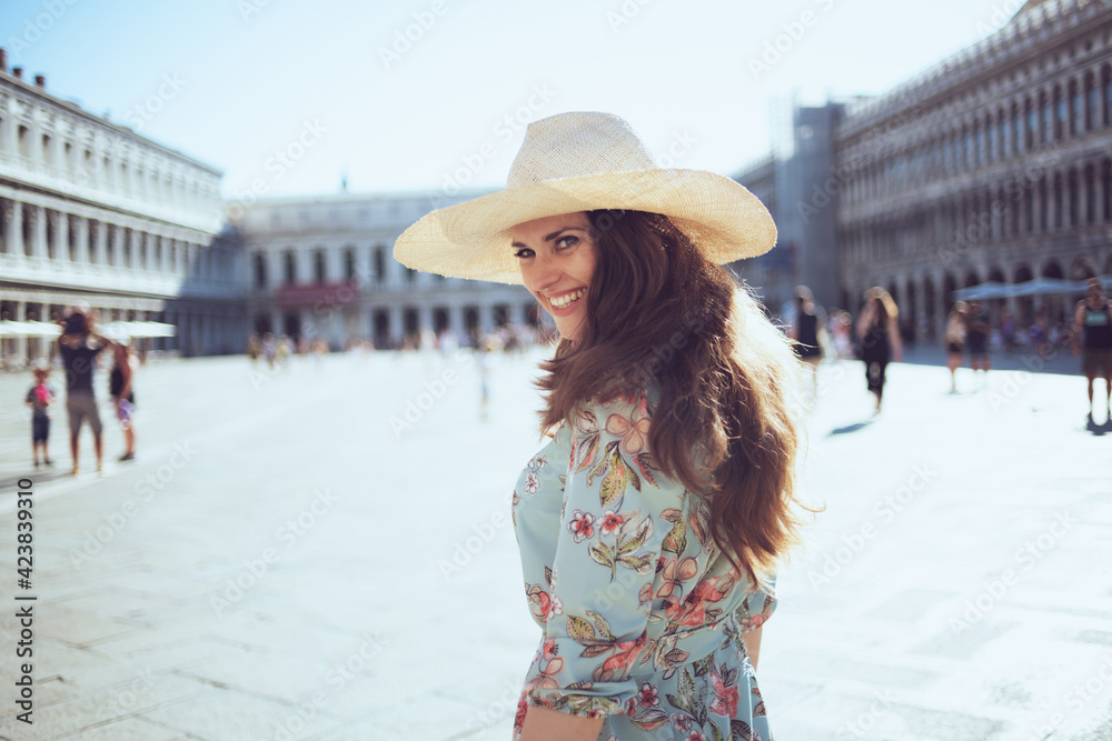 happy elegant tourist woman in floral dress sightseeing