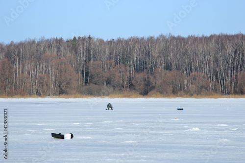 winter fishing on ice, natural background. fishermen fishing on frozen lake. Winter frosty morning fishing on river. Mozhayskoye Vodokhranilishche, Moscow Oblast, Russia Clear sunny day photo