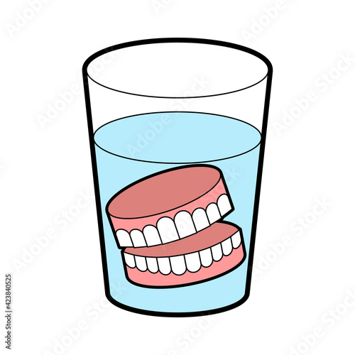 False teeth in glass. False jaw in glass beaker
