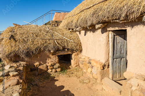 Reconstruction of a Celtiberian house made of stone and straw at Numancia archaeological site, Garray, province of Soria, Castile and Leon, Spain photo