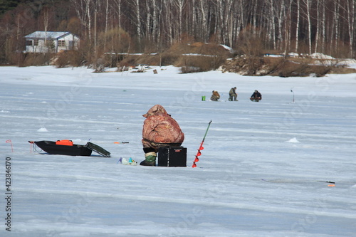 winter fishing on ice natural background. fishermen fishing. frozen lake. Winter frosty morning fishing on river. Mozhayskoye Vodokhranilishche Moscow Oblast Russia Clear sunny day Silhouettes people photo