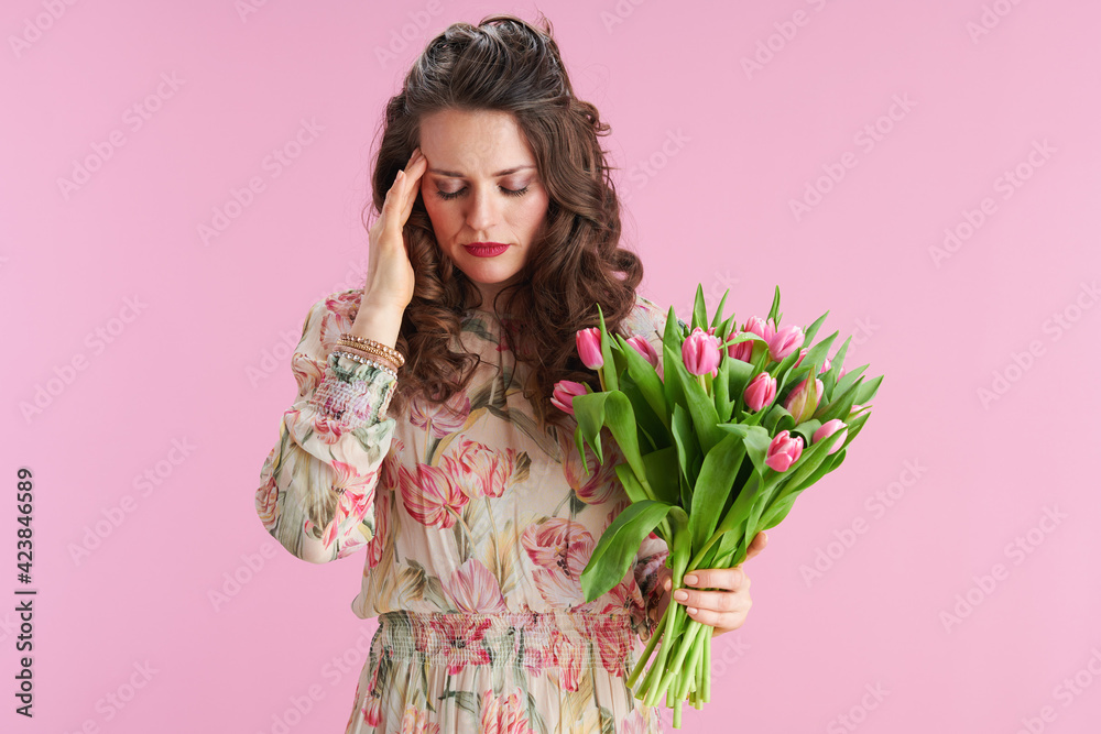 stressed modern female with long wavy brunette hair on pink