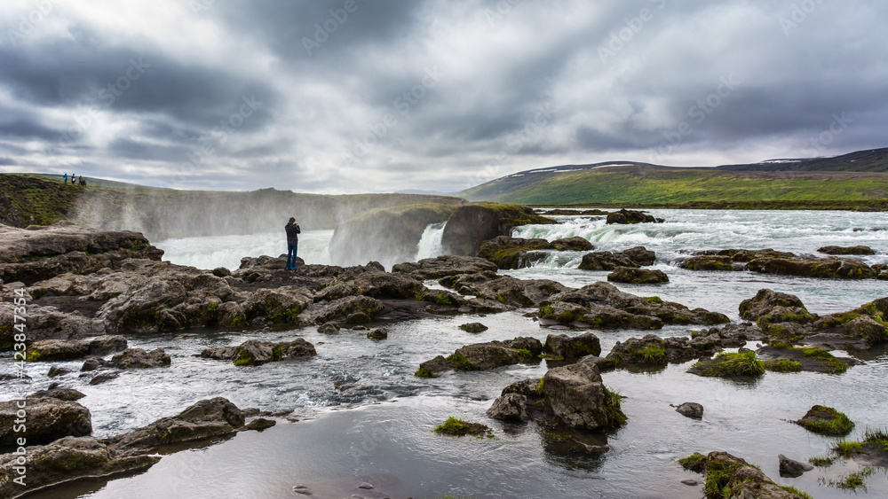 view of the majestic Godafoss waterfall near the city of Akureyri during summer season view of the majestic Godafoss waterfall near the city of Akureyri during summer season