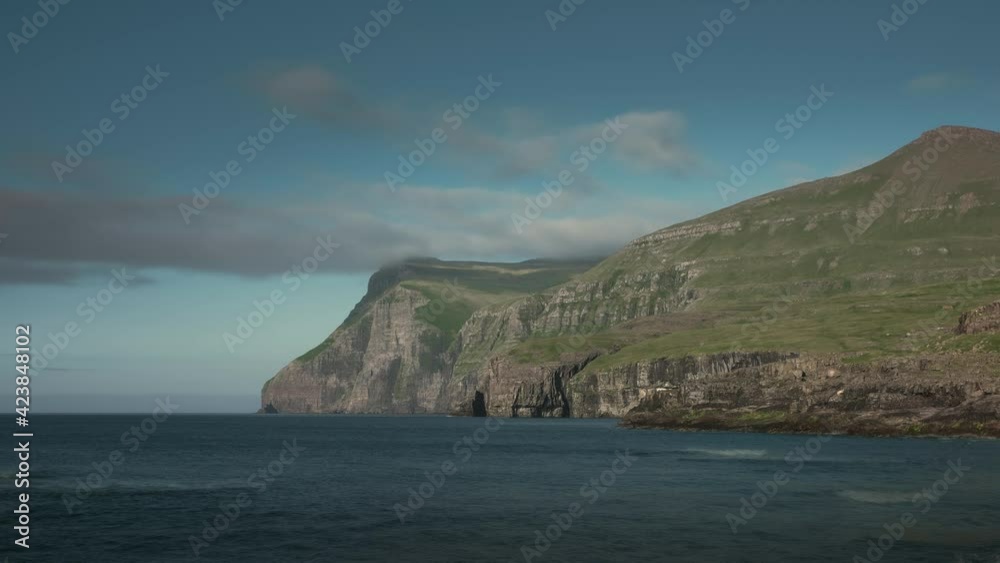Time lapse of clouds and ocean waves at coast of Eysturoy, blue sky and sun, Faroe Islands
Time lapse of clouds and ocean waves at coast of Eysturoy, blue sky and sun, Faroe Islands