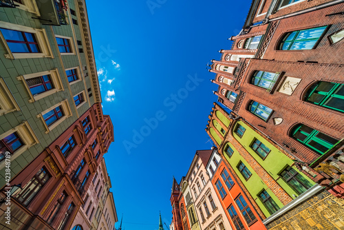 Low angle shot of colorful old tenement buildings in Torun, Poland