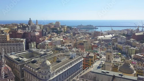 Aerial panoramic drone view of buildings and streets surrounding Port of Genoa.Important hub of maritime trade and tourist art.Old famous city of Italy,with beautiful architecture,houses,roofs.4K photo