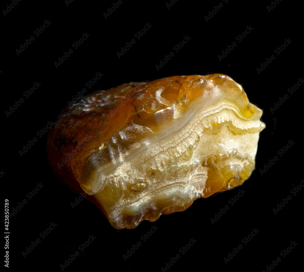 Raw agate quartz minerals nugget from Novy Urengoy, Russia. A backlight photo of stone isolated on black. Geology minerology websites, stone collection catalog, Natural Science museum wall chart Raw agate quartz minerals nugget from Novy Urengoy, Russia. A backlight photo of stone isolated on black. Geology minerology websites, stone collection catalog, Natural Science museum wall chart