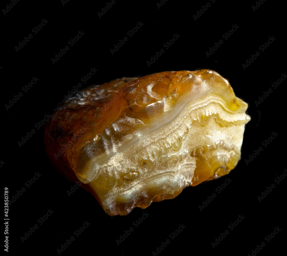 Raw agate quartz minerals nugget from Novy Urengoy, Russia. A backlight photo of stone isolated on black. Geology minerology websites, stone collection catalog, Natural Science museum wall chart