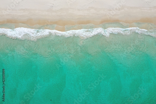 Crystal clear ocean water and sandy beach on a peaceful summer day in Perth.