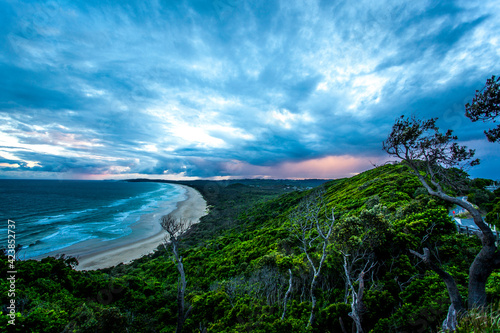 Coastal landscape with clouds and trees photo