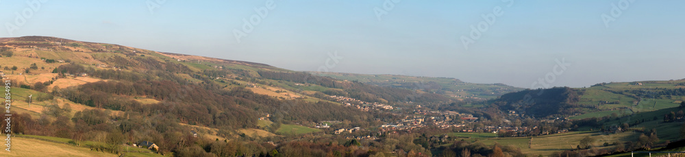 panoramic view of the calder valley in west yorkshire with the town of mytholmroyd surrounded by fields, woods and moorland