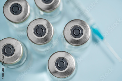 Overhead view of vials with Covid-19 vaccine and syringe