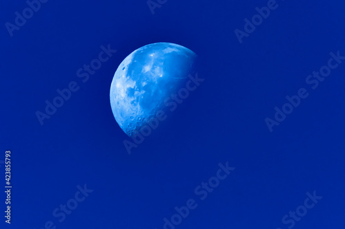 Half Moon on blue sky photo