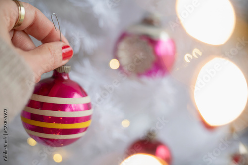 Hand decorating Christmas tree photo