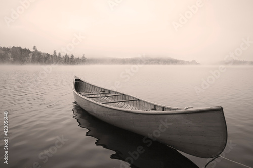 USA, New York, Santa Clara, Upper Saranac Lake, Empty canoe on Upper Saranac Lake