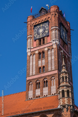 Low angle shot of the Clock Tower of Ratusz building in Torun, Poland