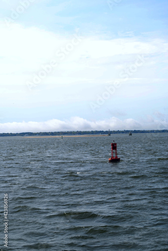 A red buoy sitting in the water