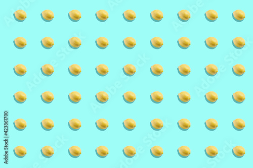 Yellow lemons pattern on light blue background. Vertical