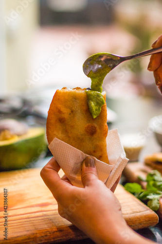 Typical empanadas of Venezuelan gastronomy with vegetables and sauce
