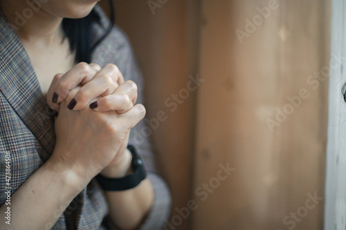 Closeup shot of a female praying at home. christian concept.