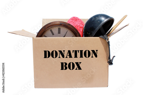 A large cardboard box filled with Yard Sale or Tag Sale items to be sold at a discount in order to make room and make some money at the same time. Yard Sales are an important part of our economy photo