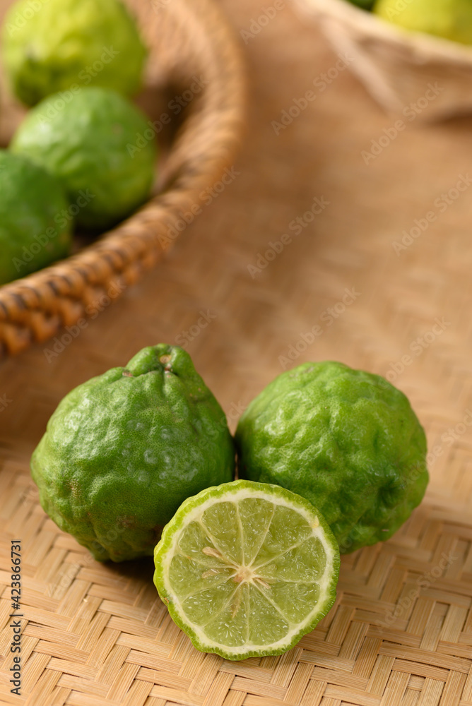 Fresh bergamot fruit on woven bamboo background, Food ingredients and extract used for medicine, tea, perfumes and cosmetics Fresh bergamot fruit on woven bamboo background, Food ingredients and extract used for medicine, tea, perfumes and cosmetics