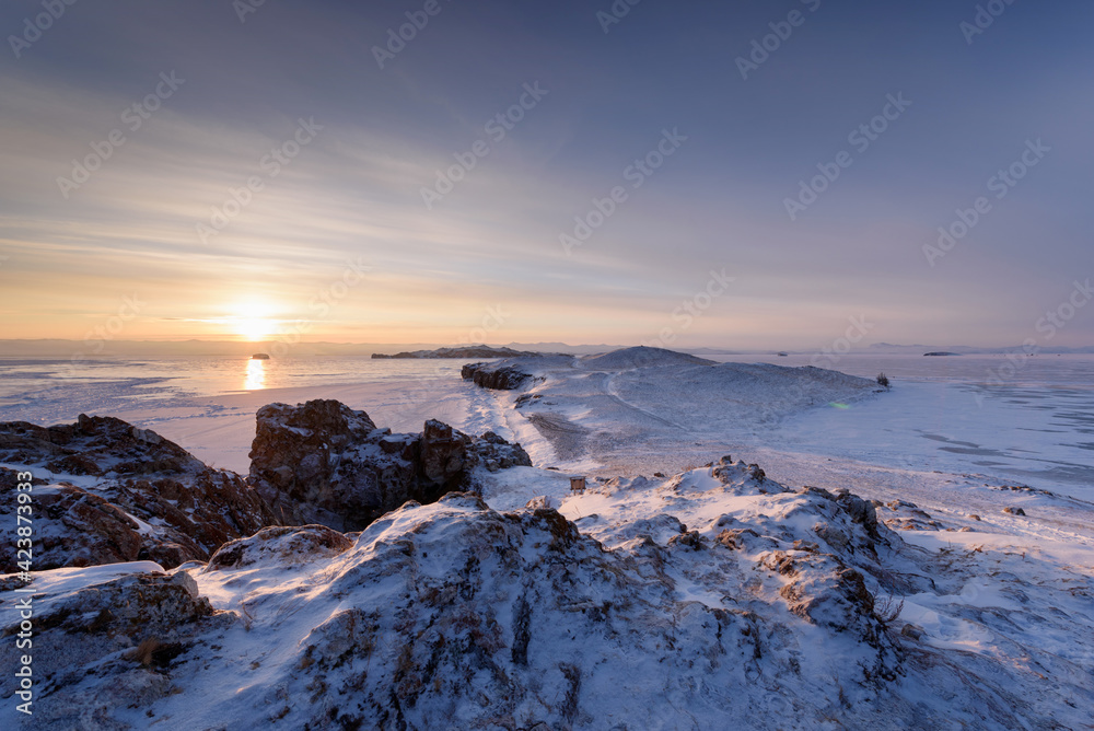 View above big beautiful frozen lake and mountain in winter, Baikal lake, Russia