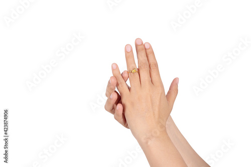 women hand-wearing wedding gold ring on her ring finger isolated on white background.