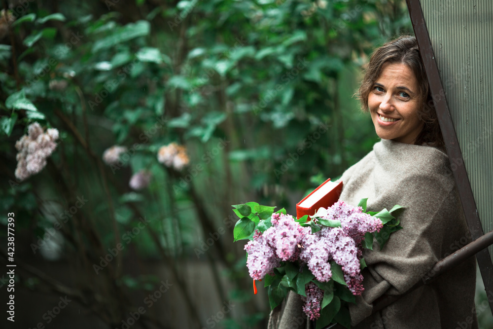 Woman with a book in his hands, outdoor among the greenery. Woman with a book in his hands, outdoor among the greenery.