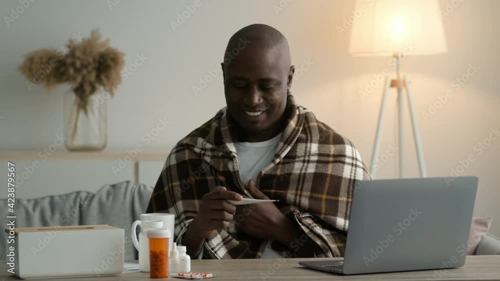 Happy African Man Holding Thermometer Measuring Temperature After Recovery Indoor Happy African Man Holding Thermometer Measuring Temperature After Recovery Indoor