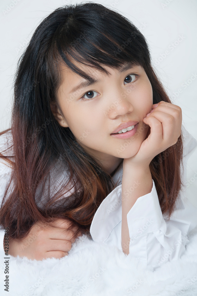 Beautiful and sexy Chinese woman wearing a white shirt isolated on a white background Beautiful and sexy Chinese woman wearing a white shirt isolated on a white background