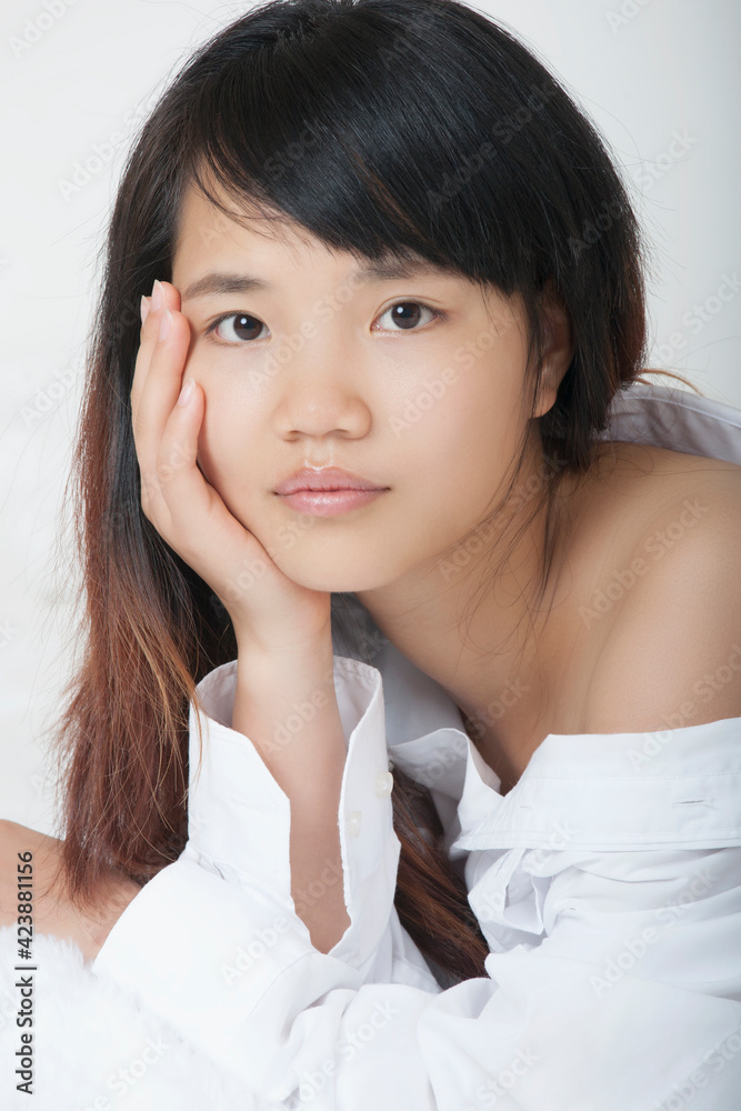 Beautiful and sexy Chinese woman wearing a white shirt isolated on a white background Beautiful and sexy Chinese woman wearing a white shirt isolated on a white background