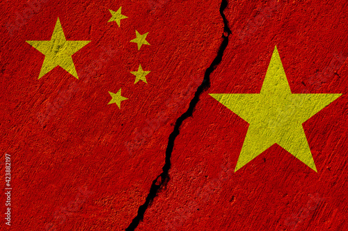 china and vietnam flags painted on concrete wall