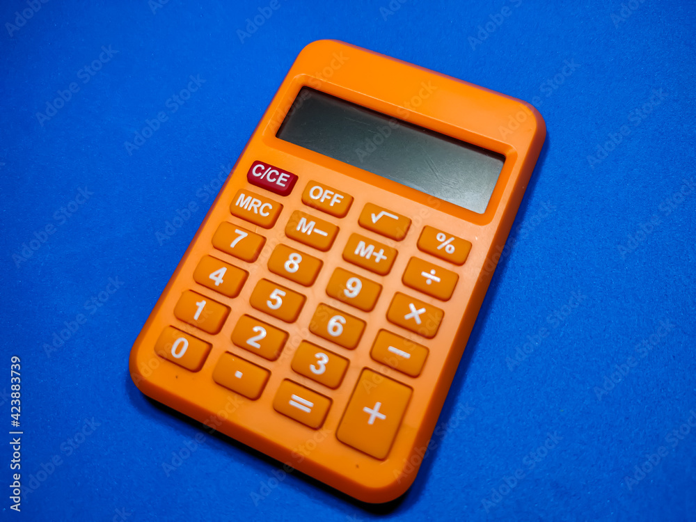 Blur calculator on blue background.Shot were noise and film grain. Blur calculator on blue background.Shot were noise and film grain.