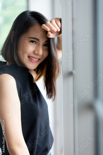 Portrait shot of a cute smiling Asian woman with a stylish straight hairstyle in black clothes standing and looking at the camera Free Download Portrait shot of a cute smiling Asian woman with a stylish straight hairstyle in black clothes standing and looking at the camera - GFXLoad