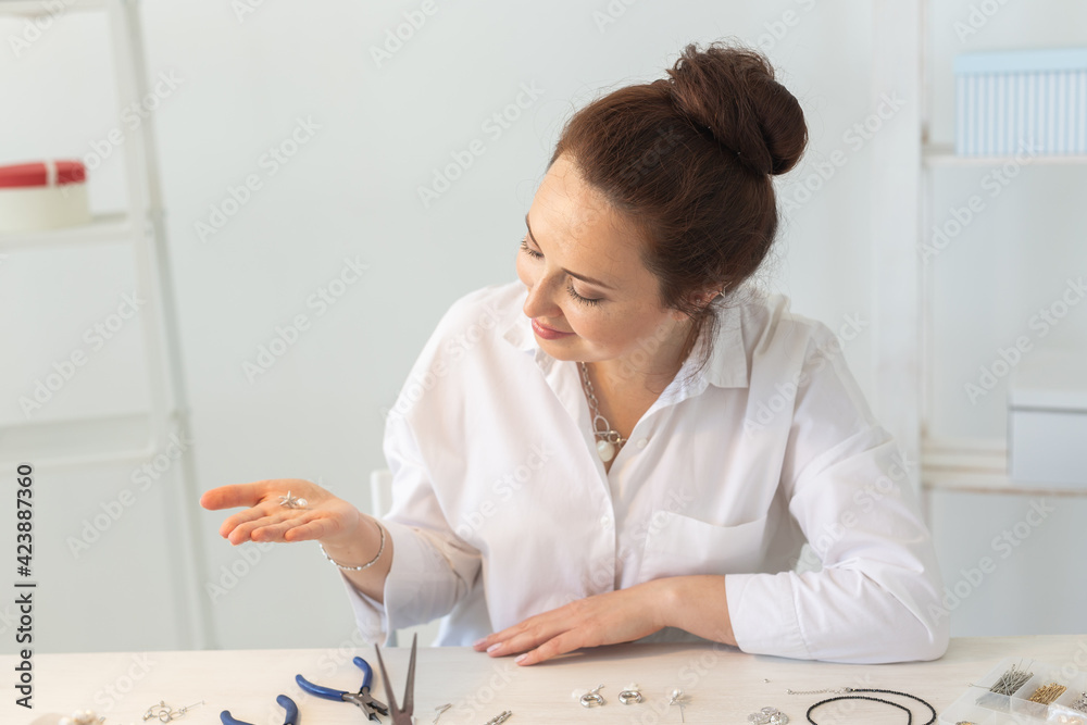 Professional accessories designer making handmade jewelry in studio workshop. Fashion, creativity and handmade concept. Professional accessories designer making handmade jewelry in studio workshop. Fashion, creativity and handmade concept.