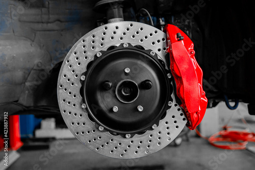Car braking system red caliper and disc photo
