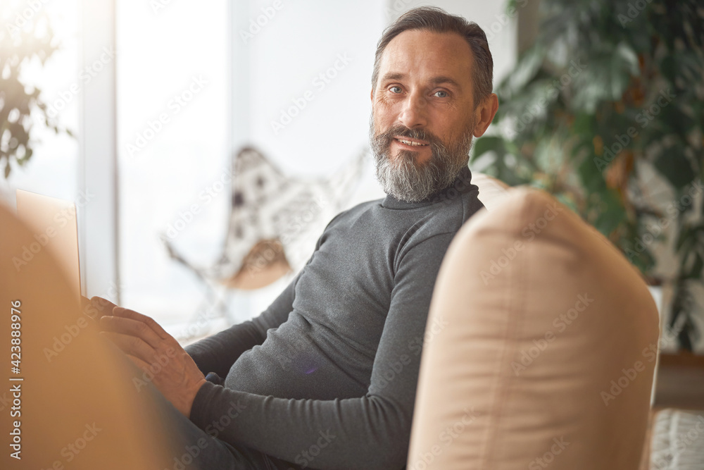 Happy adult caucasian man is working in a modern office Happy adult caucasian man is working in a modern office