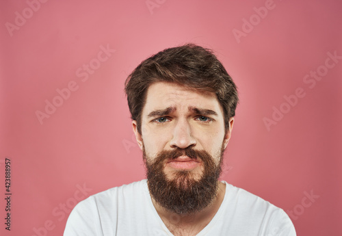 Male cropped view portrait of brunet bushy beard white t-shirt