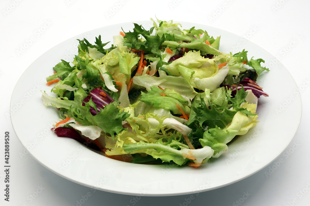 Fresh mixed green salad in a bowl isolated on white background Fresh mixed green salad in a bowl isolated on white background