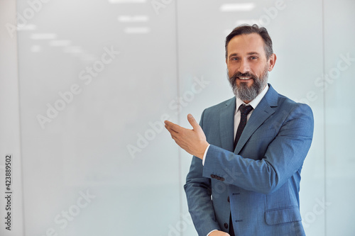 Happy adult caucasian man is working in a modern office