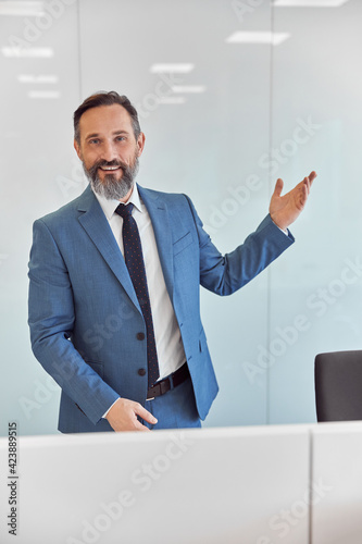 Happy adult caucasian man is working in a modern office