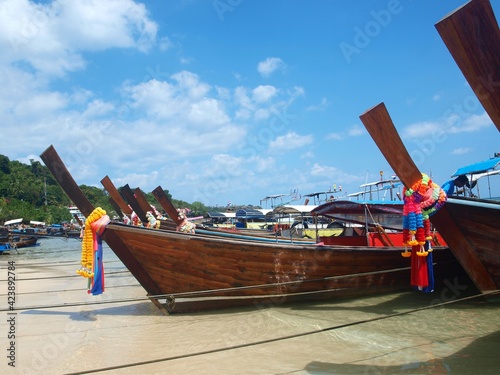 Group of Thai longtail boats on a sand on the coast. Typical view of Thailand. Tour tourism by the sea. The main attractions of Thailand for tourists, island travel. Phuket, Koh Samui, Phi Phi, Krabi