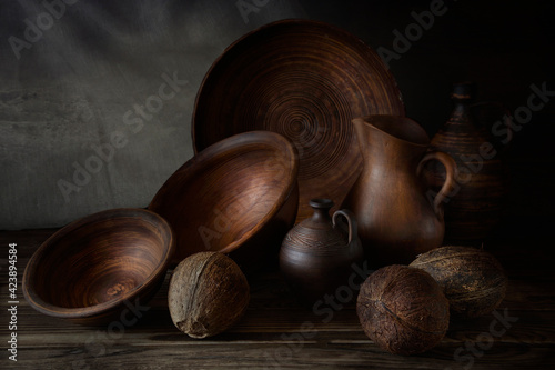 Nuts in an earthenware dish on a wooden table.