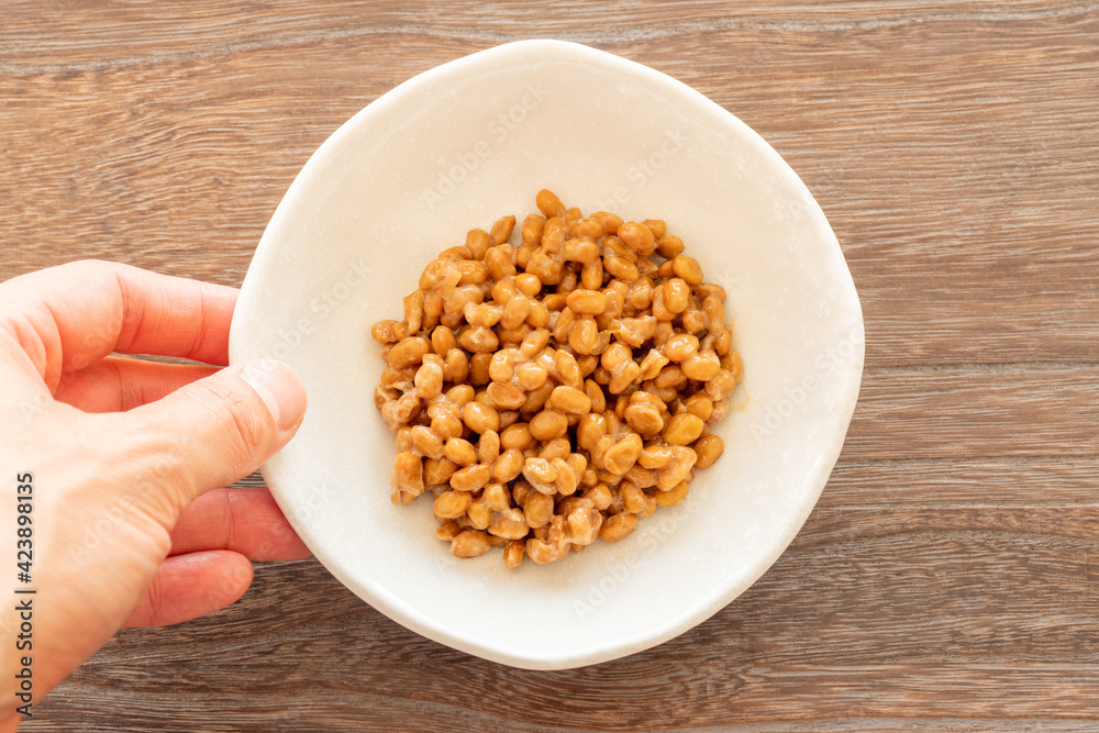 納豆の皿を木製テーブルに置く 納豆の皿を木製テーブルに置く