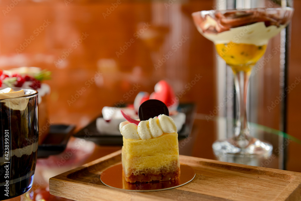Dessert stand in cafe. Glass stand with different cakes and desserts, sweet food. Eating out concept