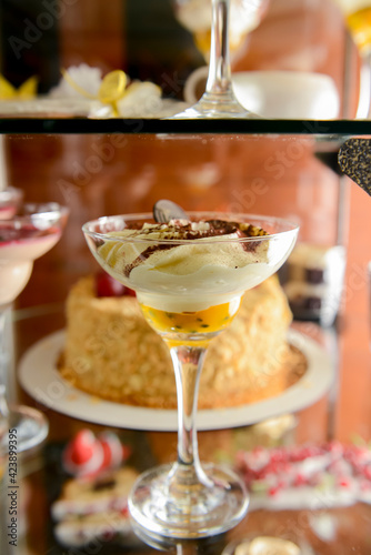 Dessert stand in cafe. Glass stand with different cakes and desserts, sweet food. Eating out concept