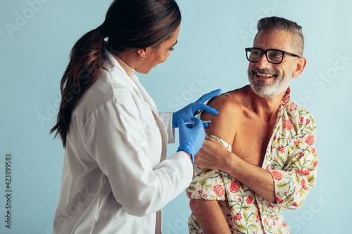 Doctor giving flu shot to patient