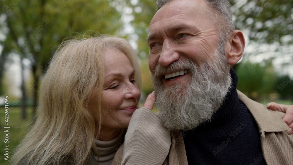 Close up portrait of married couple having fun outdoors. Smiling aged man .